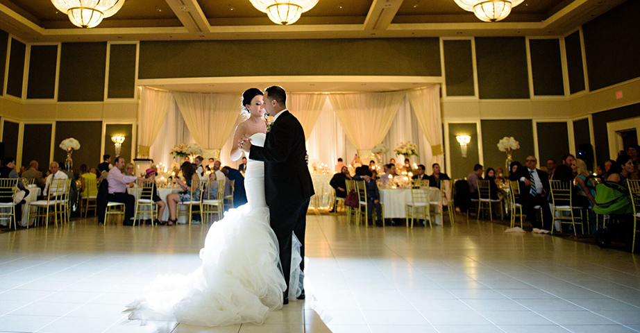 Wedding Couple Dancing in the Large Ballroom